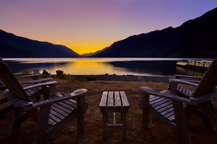 Chairs lining Lake Crescent's shore invite you to watch the sunset