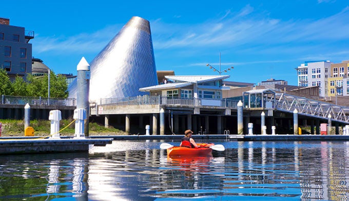 Tacoma-Glass-Museum-Dome-Kayak_DP_680 A kayaker in Tacoma’s downtown marina with the Glass Museum Dome in the background
